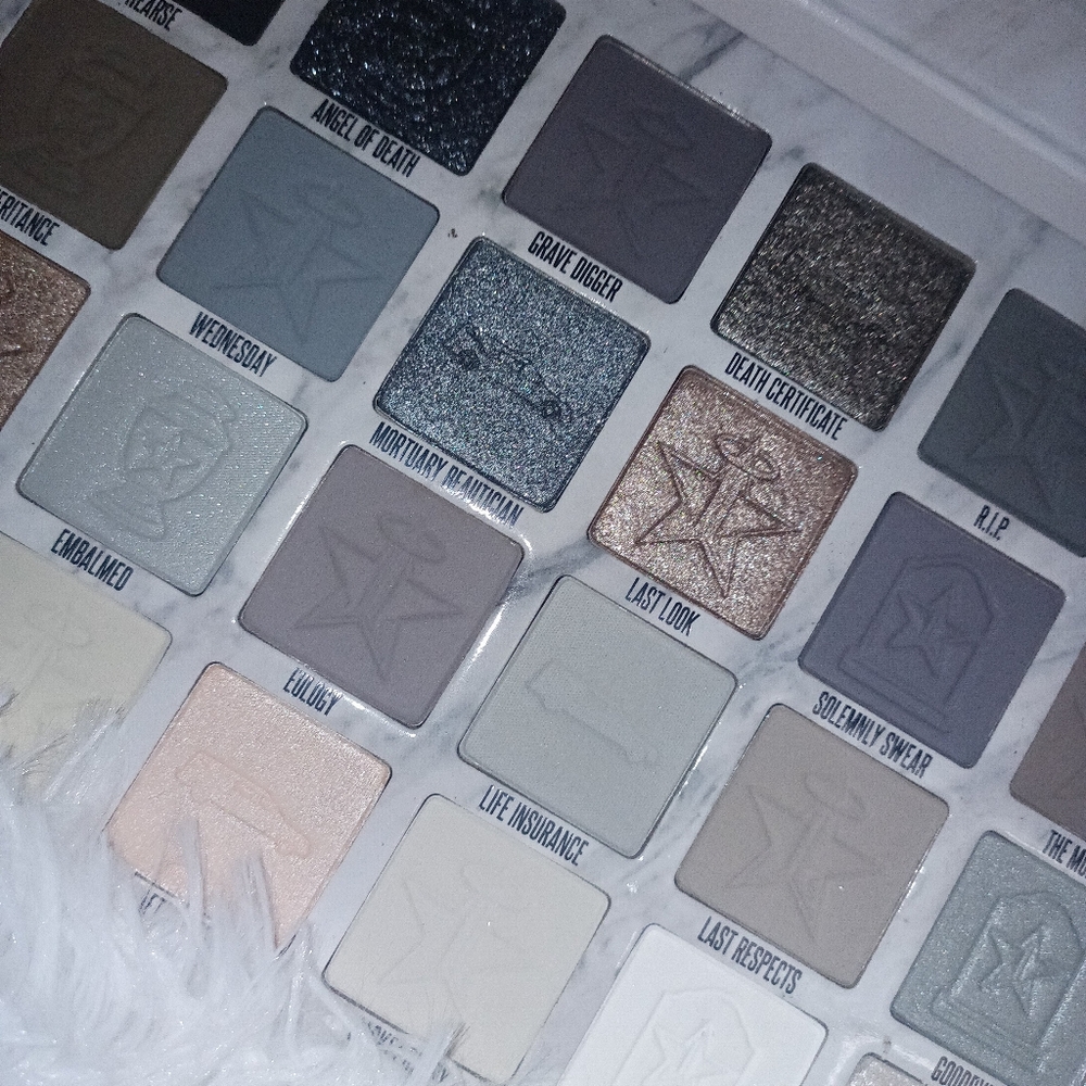 Jeffree Star CREMATED pallette with all white throw blanket.